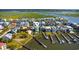 Stunning aerial view of a waterfront neighborhood with houses, docks, lush greenery and tranquil waterways at 1510 North Shore Dr, Sunset Beach, NC 28468