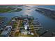 Stunning aerial view of waterfront home with private dock, pool and lush landscaping at 1510 North Shore Dr, Sunset Beach, NC 28468