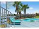 Relaxing backyard featuring a pool, blue deck, palm trees and lounge chairs offering an outdoor retreat at 1510 North Shore Dr, Sunset Beach, NC 28468