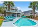 Expansive backyard featuring a pool, blue deck, lounge chairs, and fenced yard providing a perfect outdoor space at 1510 North Shore Dr, Sunset Beach, NC 28468