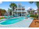 Expansive backyard featuring a pool, blue deck, lounge chairs, and fenced yard providing the perfect outdoor space at 1510 North Shore Dr, Sunset Beach, NC 28468