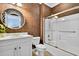 Bathroom featuring patterned wallpaper, a modern vanity, and a shower-tub combination at 1510 North Shore Dr, Sunset Beach, NC 28468