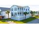 Charming two-story white home with green metal roof, double balconies and well-manicured lawn at 1510 North Shore Dr, Sunset Beach, NC 28468