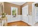 Charming foyer featuring hardwood floors, textured walls, and a bright window at 1510 North Shore Dr, Sunset Beach, NC 28468
