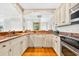 A chef's kitchen with granite countertops, stainless appliances, and ample cabinet space at 1510 North Shore Dr, Sunset Beach, NC 28468