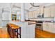 Modern kitchen with granite countertops, stainless appliances, and adjacent breakfast bar seating at 1510 North Shore Dr, Sunset Beach, NC 28468