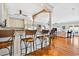 Open kitchen featuring a breakfast bar with wicker chairs and a view of the living room at 1510 North Shore Dr, Sunset Beach, NC 28468