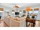 Bright living room featuring a comfortable sectional sofa, ceiling fan, and water views at 1510 North Shore Dr, Sunset Beach, NC 28468