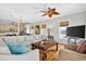 Inviting living room with plush seating, modern TV, wood floors, and a view into the kitchen at 1510 North Shore Dr, Sunset Beach, NC 28468
