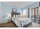 Light and airy bedroom with balcony view and two side tables at 1605 S Ocean Blvd. # 208, Myrtle Beach, SC 29577