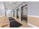 Hallway with elevators and bench that offers easy access to upper level floors at 1605 S Ocean Blvd. # 208, Myrtle Beach, SC 29577