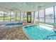 Indoor pool surrounded by palm trees and glass walls, creating a tropical atmosphere at 1605 S Ocean Blvd. # 208, Myrtle Beach, SC 29577