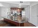 Kitchen features a breakfast bar, stainless steel appliances, dark wood cabinets, tile backsplash, and updated fixtures at 1605 S Ocean Blvd. # 208, Myrtle Beach, SC 29577
