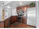 Kitchen features stainless steel appliances, dark wood cabinets, granite countertops, and tile flooring at 1605 S Ocean Blvd. # 208, Myrtle Beach, SC 29577