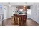 Well-equipped kitchen featuring a breakfast bar, stainless steel appliances, dark wood cabinets, and tile floors at 1605 S Ocean Blvd. # 208, Myrtle Beach, SC 29577
