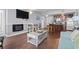 Cozy living room showcasing an electric fireplace, television, kitchen access, and an ocean view through a window at 1605 S Ocean Blvd. # 208, Myrtle Beach, SC 29577
