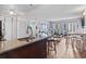 Open-concept living area showcasing a modern kitchen with granite counters and a view to the outdoor balcony at 1605 S Ocean Blvd. # 208, Myrtle Beach, SC 29577