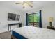 Bright bedroom with a large window view, ceiling fan, TV, and table at 1809 Crooked Pine Dr. # G3, Surfside Beach, SC 29575