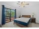 Bedroom with bed, ceiling fan, sliding glass door to balcony, and lamps on the night stands at 1809 Crooked Pine Dr. # G3, Surfside Beach, SC 29575