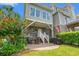 Inviting back patio with outdoor seating, grill, and lush landscaping at 1907 Enclave Ln. # 1907, North Myrtle Beach, SC 29582