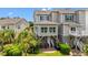 Beautiful backyard with a patio, tropical landscaping, and serene green space at 1907 Enclave Ln. # 1907, North Myrtle Beach, SC 29582