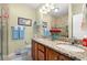 Well-lit bathroom with double sinks, granite countertops, and a decorative mirror at 1907 Enclave Ln. # 1907, North Myrtle Beach, SC 29582