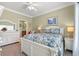 Comfortable bedroom featuring neutral carpet, a plush bed, and an ensuite bathroom at 1907 Enclave Ln. # 1907, North Myrtle Beach, SC 29582
