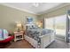 Cozy bedroom with a plush bed, floral comforter, and bright natural light from the window at 1907 Enclave Ln. # 1907, North Myrtle Beach, SC 29582