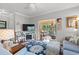 Bright living room featuring hardwood floors, comfortable seating, and a smooth transition into the sun room at 1907 Enclave Ln. # 1907, North Myrtle Beach, SC 29582