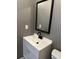 Bathroom featuring a sleek vanity with a black faucet and a well lit mirror at 2005 Greens Blvd. # D301, Myrtle Beach, SC 29577