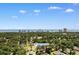 Aerial view of the house in a wooded area, with city skyline in the distance at 207 Green Lake Dr., Myrtle Beach, SC 29572