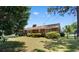 Expansive backyard featuring lush green grass and mature shrubs and trees at 207 Green Lake Dr., Myrtle Beach, SC 29572