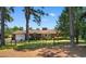 View of the house from backyard, featuring a fenced yard and mature trees at 207 Green Lake Dr., Myrtle Beach, SC 29572