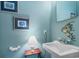 Bright powder room with light blue walls, white sink, fish themed decor, and stylish fixtures at 207 Green Lake Dr., Myrtle Beach, SC 29572
