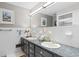 Well-lit bathroom with a double vanity, white tile, and updated fixtures at 207 Green Lake Dr., Myrtle Beach, SC 29572