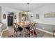 Dining area featuring a wooden table, stylish chairs, and elegant lighting at 207 Green Lake Dr., Myrtle Beach, SC 29572