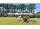 Charming single-story brick home with well-manicured front yard and mature trees at 207 Green Lake Dr., Myrtle Beach, SC 29572
