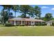 Charming single-story brick home with a well-manicured lawn and mature trees at 207 Green Lake Dr., Myrtle Beach, SC 29572