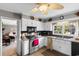 Cozy kitchen featuring white cabinets, stainless steel appliances, and a ceiling fan at 207 Green Lake Dr., Myrtle Beach, SC 29572