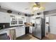 Bright kitchen with stainless steel refrigerator, white cabinets, and modern countertops at 207 Green Lake Dr., Myrtle Beach, SC 29572