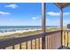View from a balcony showing a picturesque beach scene with blue skies and clear water at 208 N Ocean Blvd. # 226, North Myrtle Beach, SC 29582