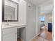 Bathroom sink and mirror with an adjacent entry to the bedroom, as well as a view of the beach at 208 N Ocean Blvd. # 226, North Myrtle Beach, SC 29582