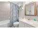 Bathroom with tub/shower combo, blue patterned shower curtain, and light granite vanity at 208 N Ocean Blvd. # 226, North Myrtle Beach, SC 29582