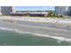 Expansive beach view with ocean waves, beachgoers, and nearby buildings along the coast at 208 N Ocean Blvd. # 226, North Myrtle Beach, SC 29582