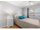 Bright bedroom featuring wood floors, white furniture, and a large window providing natural light at 208 N Ocean Blvd. # 226, North Myrtle Beach, SC 29582