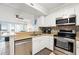Modern kitchen with stainless steel appliances and an open view into the living area at 208 N Ocean Blvd. # 226, North Myrtle Beach, SC 29582