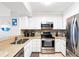 Well-lit kitchen with stainless steel appliances, white cabinetry, and speckled countertops at 208 N Ocean Blvd. # 226, North Myrtle Beach, SC 29582