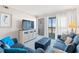 Comfortable living room with balcony access, a mounted TV, and plush seating at 208 N Ocean Blvd. # 226, North Myrtle Beach, SC 29582