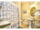 Nautical themed bathroom features a pedestal sink, patterned shower curtain, and decorative shelving at 2180 Waterview Dr. # 1013, North Myrtle Beach, SC 29582