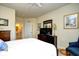 Inviting bedroom featuring a TV, dresser, and a glimpse of an en-suite bathroom at 2180 Waterview Dr. # 1013, North Myrtle Beach, SC 29582